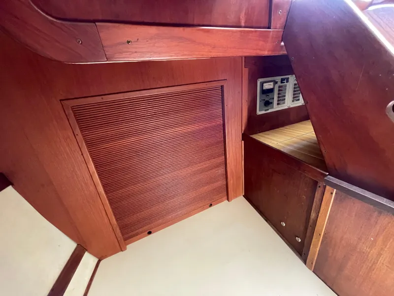 Slide: The Image of Interior of 1978 CAL 2-39 sailboat, featuring wooden paneling and control panel. - 20