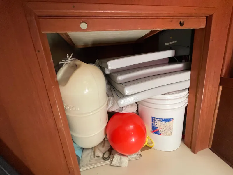 Slide: The Image of Storage compartment on a 1978 CAL 2-39 boat with marine equipment and supplies. - 21
