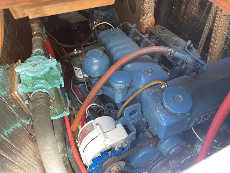 Slide: The Image of Engine compartment of a 1978 CAL 2-39 sailboat, featuring a blue marine engine. - 22