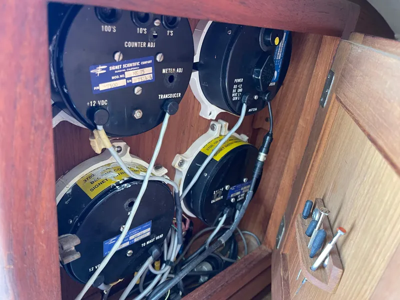 Slide: The Image of Electrical panel inside a 1978 CAL 2-39 sailboat, featuring various gauges and wiring. - 28