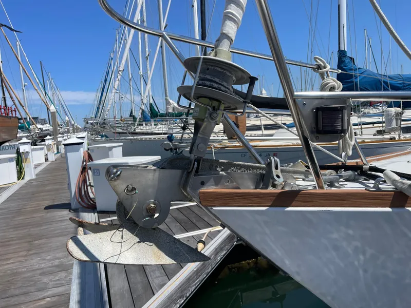 Slide: The Image of 1978 CAL 2-39 sailboat docked, showcasing anchor and rigging details under clear blue sky. - 30