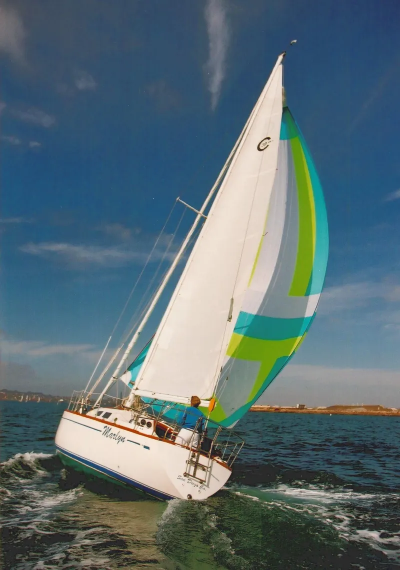 Slide: The Image of Sailing yacht CAL 2-39, 1978 model, with colorful spinnaker on open water. - 35