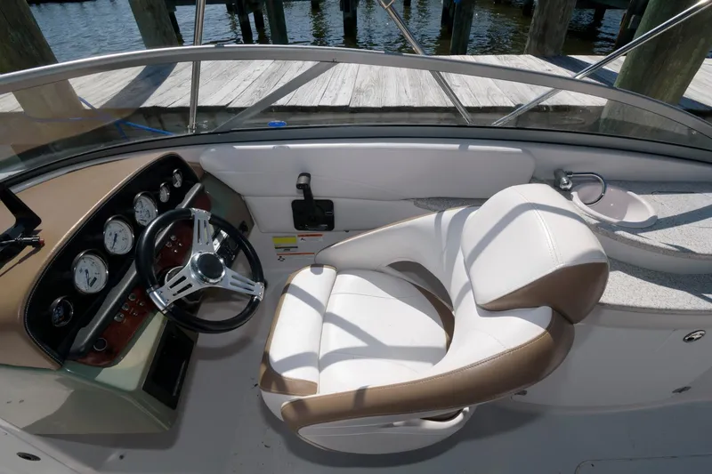 Slide: The Image of 2009 Four Winns 274 Funship boat cockpit with steering wheel and captain's chair. - 4