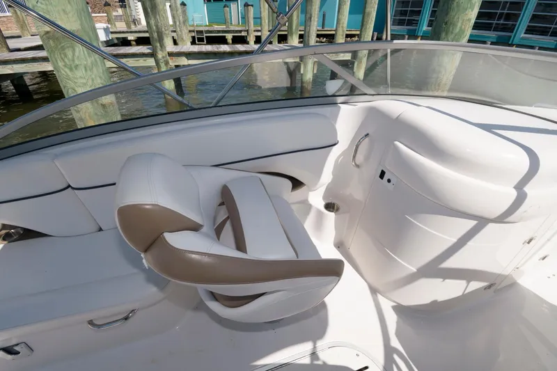 Slide: The Image of 2009 Four Winns 274 Funship boat interior with white and beige seating. - 6