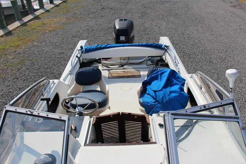 Slide: The Image of 1985 Boston Whaler Revenge 22 boat interior with steering wheel and seating. - 13