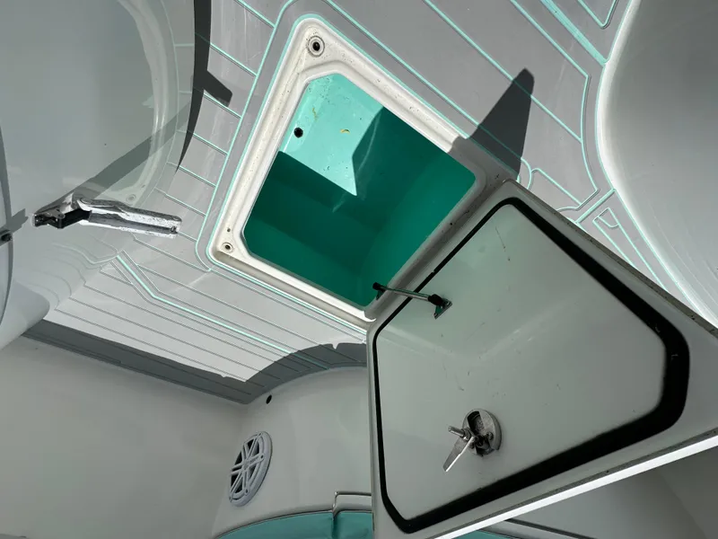 Slide: The Image of 2018 Contender 24 Sport boat storage compartment with open hatch. - 10
