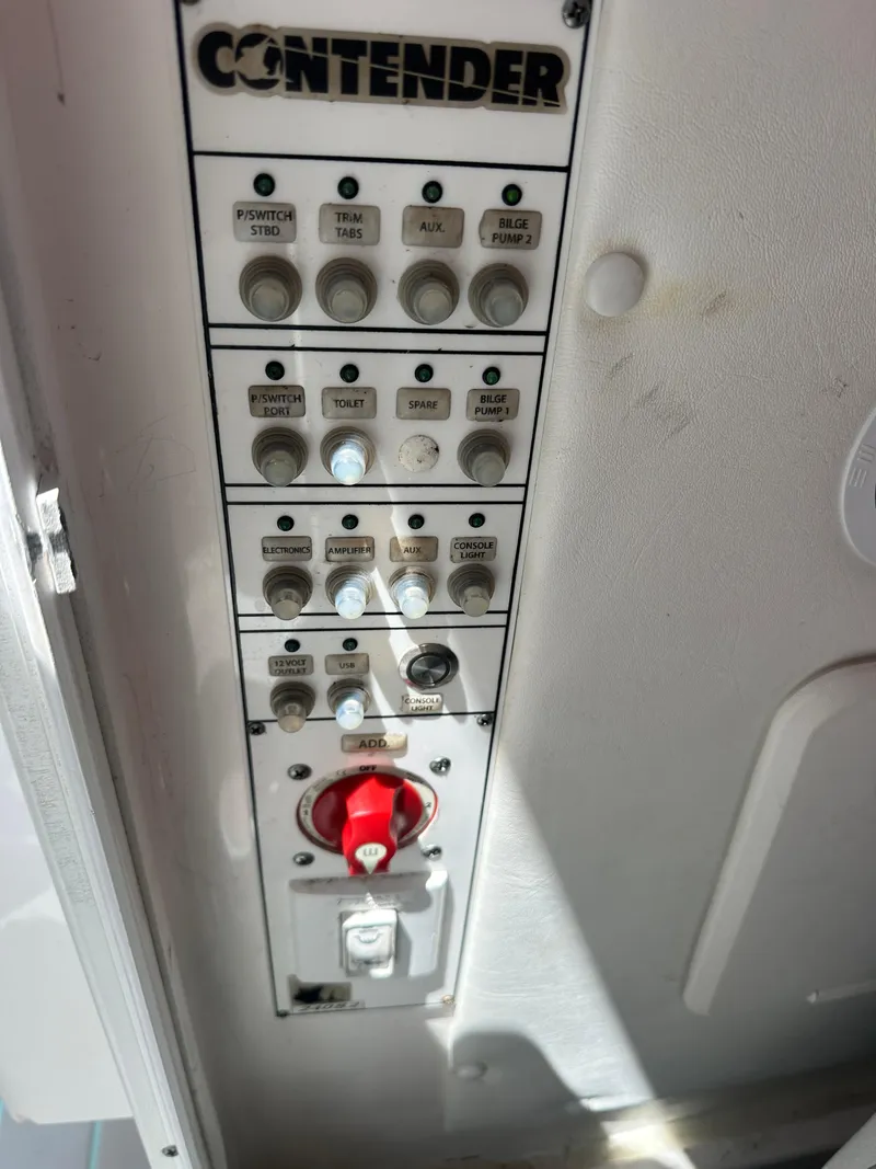 Slide: The Image of Control panel of a 2018 Contender 24 Sport boat. - 11