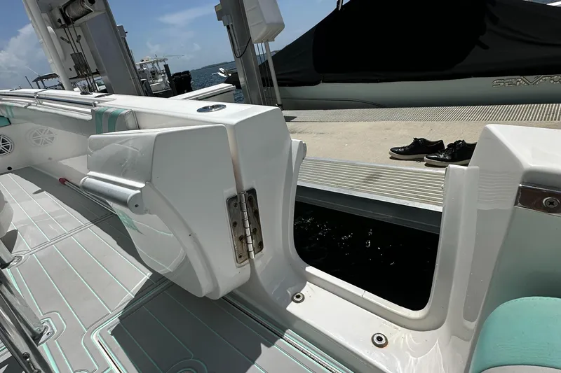 Slide: The Image of 2018 Contender 24 Sport boat with open side door at dock. - 16