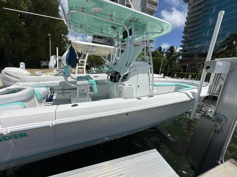 Slide: The Image of 2018 Contender 24 Sport boat docked at marina with modern design. - 4