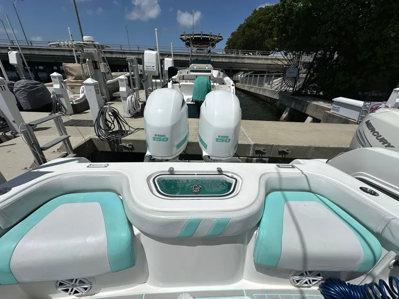 Slide: The Image of 2018 Contender 24 Sport boat with twin engines docked at marina. - 5
