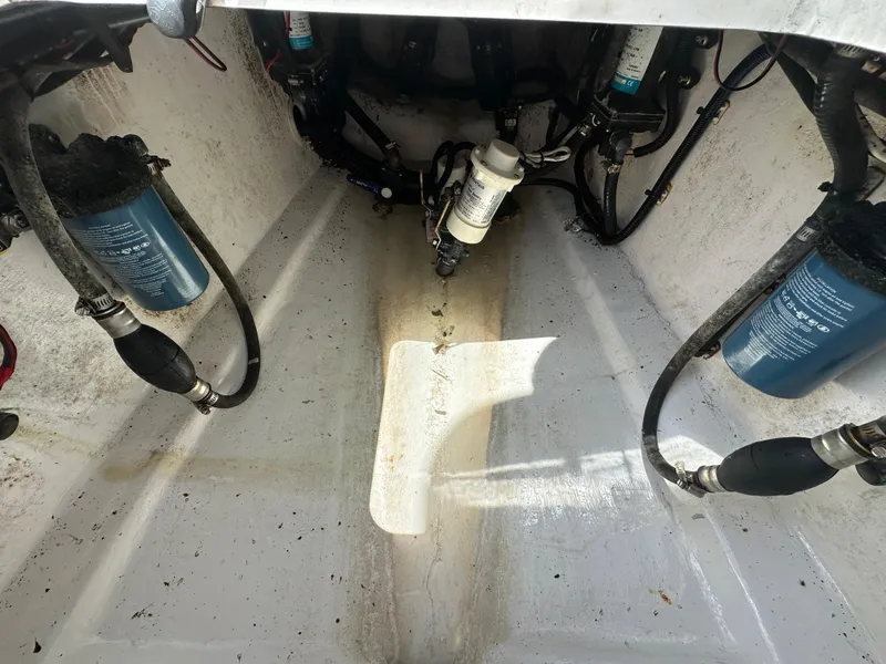 Slide: The Image of 2018 Contender 24 Sport boat engine compartment with fuel filters and hoses. - 7