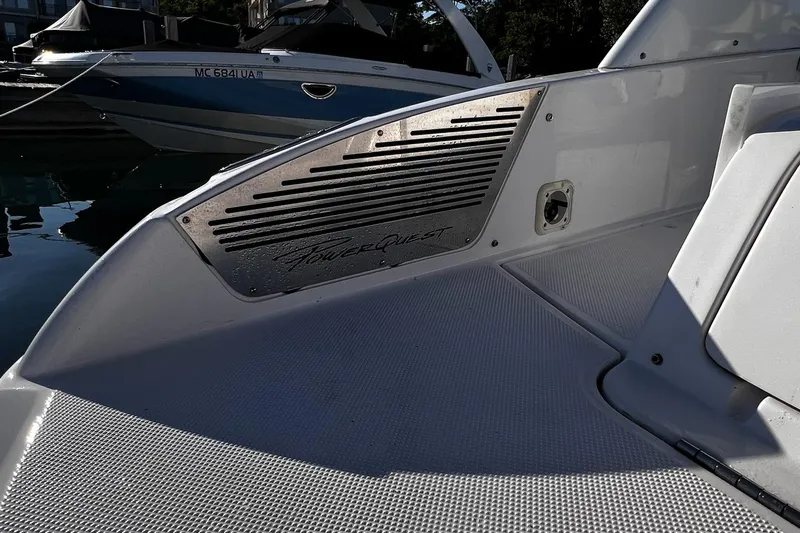 Slide: The Image of 2003 Powerquest 280 SC boat deck with logo and seating area. - 16