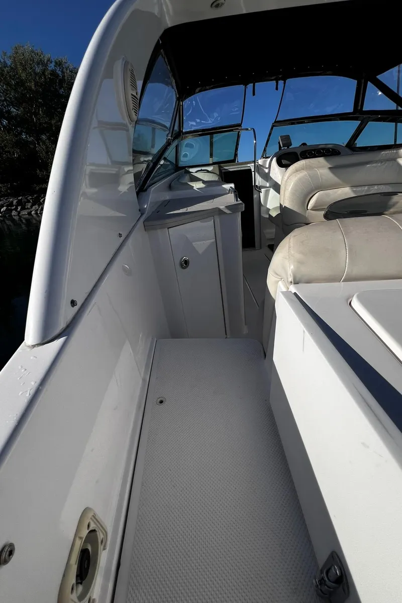 Slide: The Image of 2003 Powerquest 280 SC boat interior with white seating and dashboard. - 18