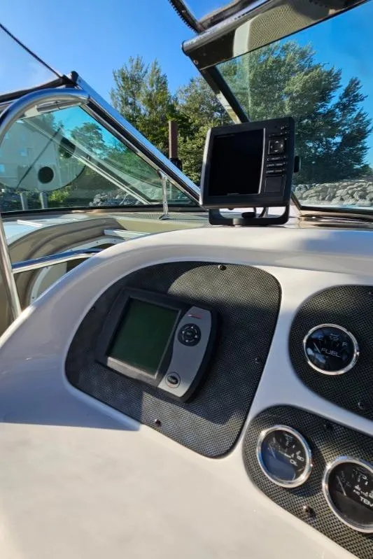 Slide: The Image of 2003 Powerquest 280 SC boat dashboard with navigation equipment and gauges. - 20