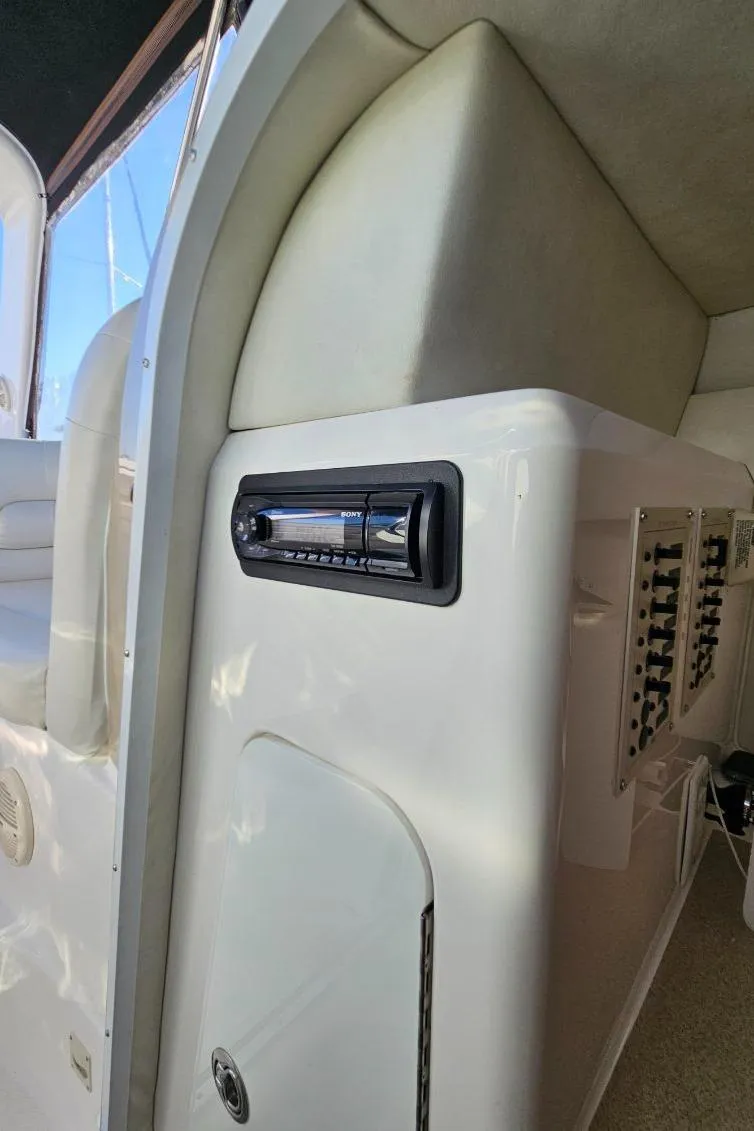 Slide: The Image of 2003 Powerquest 280 SC boat interior control panel and seating. - 22