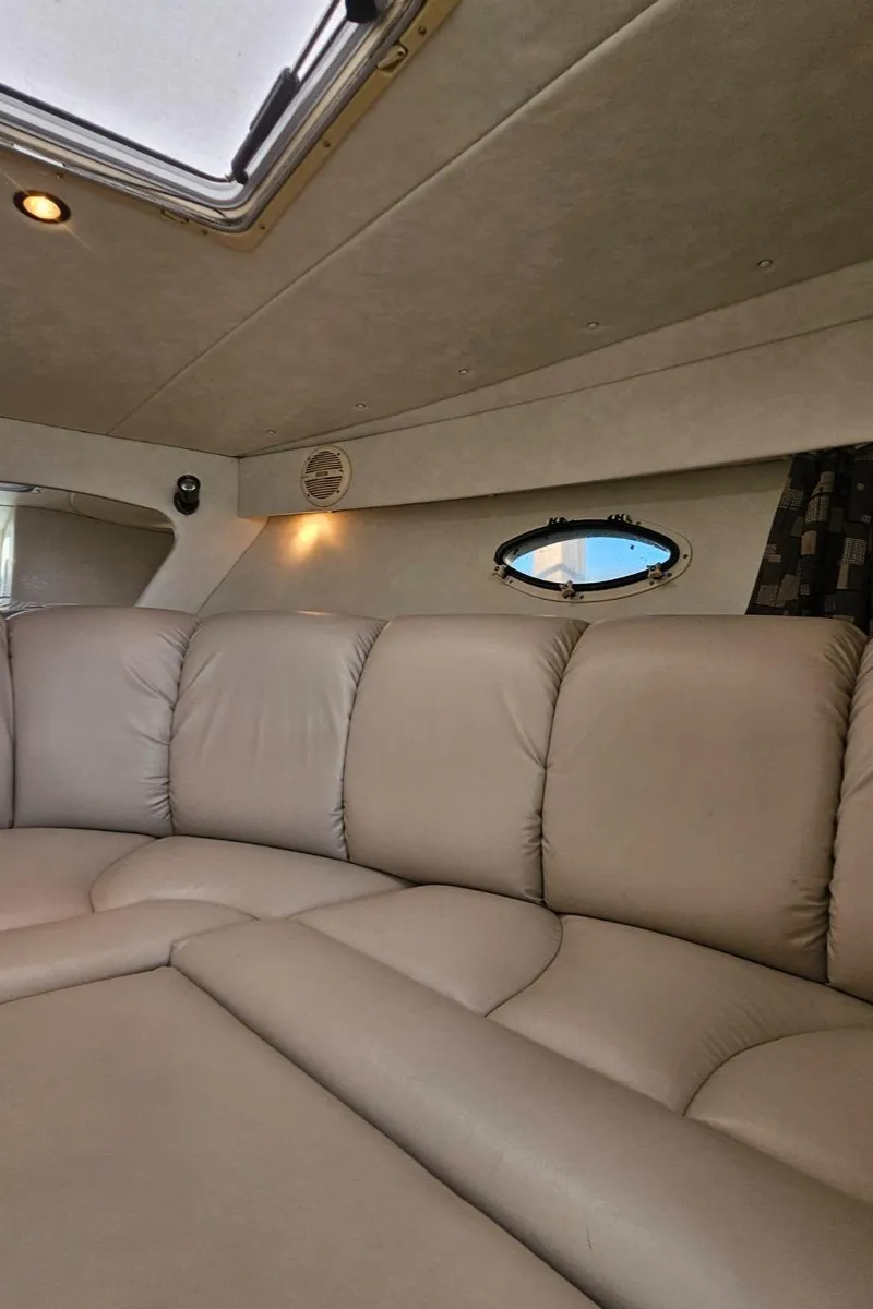Slide: The Image of Interior of 2003 Powerquest 280 SC boat with beige leather seating. - 28