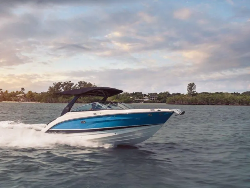 Slide: The Image of 2023 Sea Ray SLX 260 boat cruising on a scenic waterway. - 10