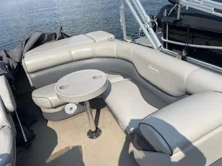 Slide: The Image of 2018 Premier 220 SunSation pontoon boat with gray seating and a small table. - 3