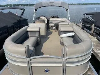 Slide: The Image of 2018 Premier 220 SunSation pontoon boat docked on a lake. - 6
