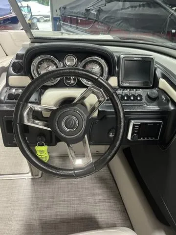Slide: The Image of 2020 Crownline 235 SS boat dashboard with steering wheel and control panel. - 8