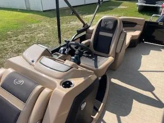 Slide: The Image of 2023 Barletta Cabrio 22QC boat interior with tan and black seating. - 2