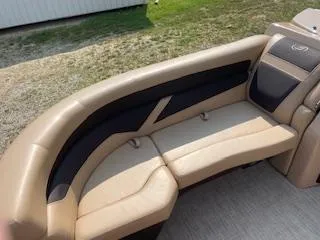 Slide: The Image of 2023 Barletta Cabrio 22QC boat with tan and black cushioned seating. - 3