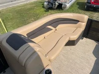 Slide: The Image of 2023 Barletta Cabrio 22QC boat with tan and black cushioned seating. - 5