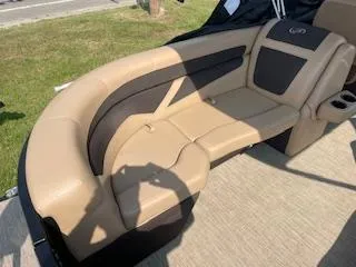 Slide: The Image of 2023 Barletta Cabrio 22QC boat with tan and black cushioned seating. - 6