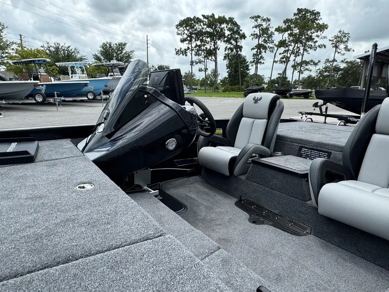 Slide: The Image of 2025 Phoenix 920 Elite 2 boat interior with steering console and seating. - 11