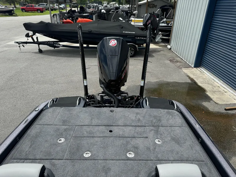 Slide: The Image of 2025 Phoenix 920 Elite 2 boat with outboard motor in a marina. - 18