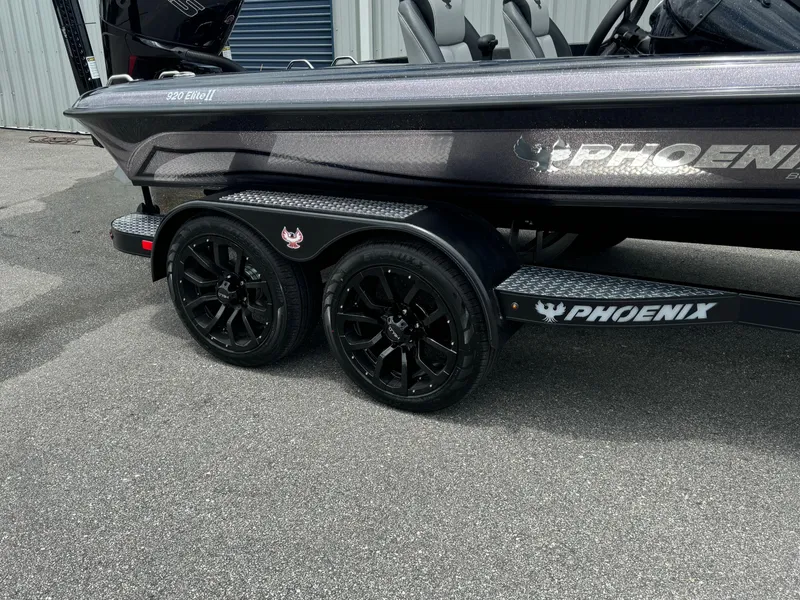 Slide: The Image of 2025 Phoenix 920 Elite 2 boat on a black dual-axle trailer. - 19