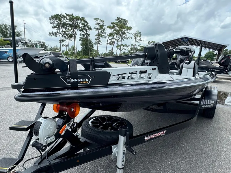 Slide: The Image of 2025 Phoenix 920 Elite 2 boat with Minn Kota motor on trailer. - 2