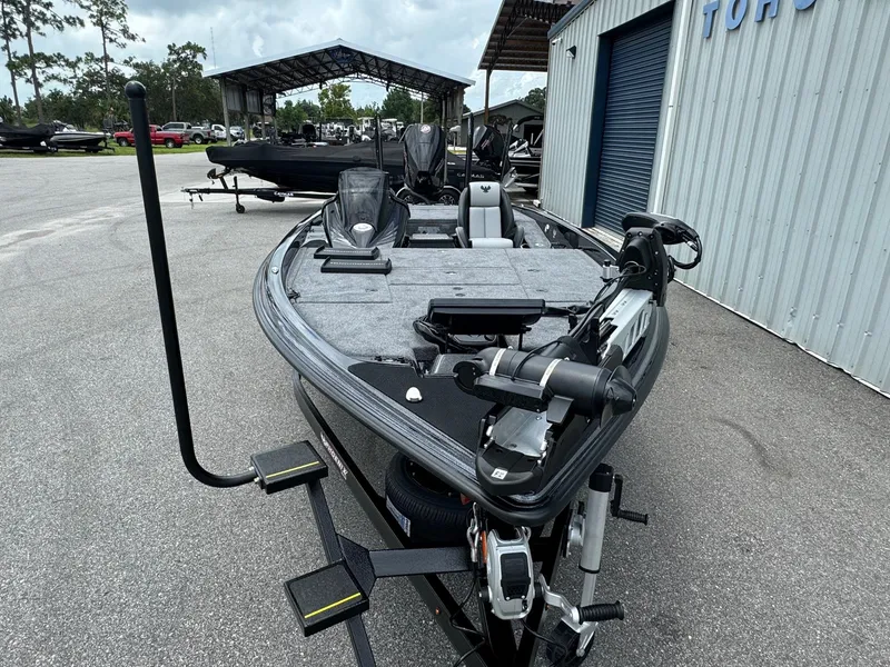Slide: The Image of 2025 Phoenix 920 Elite 2 fishing boat in a marina. - 5