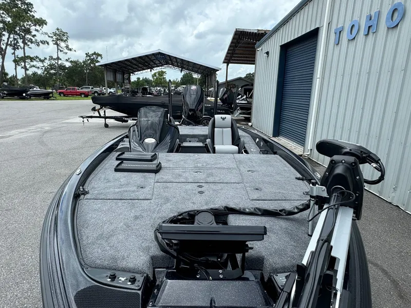 Slide: The Image of 2025 Phoenix 920 Elite 2 fishing boat docked near a warehouse. - 6