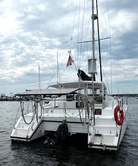 The Image of 2010 Gemini 105Mc catamaran docked in a marina under cloudy skies. - 0