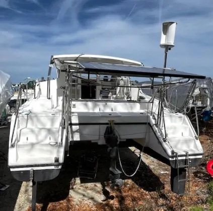 Slide: The Image of 2010 Gemini 105Mc catamaran on land, under a clear blue sky. - 12