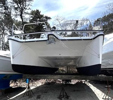Slide: The Image of 2010 Gemini 105Mc catamaran on stands, viewed from the front, outdoors. - 20