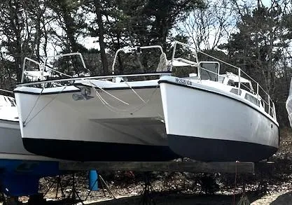Slide: The Image of 2010 Gemini 105Mc catamaran on dry dock, surrounded by trees. - 21