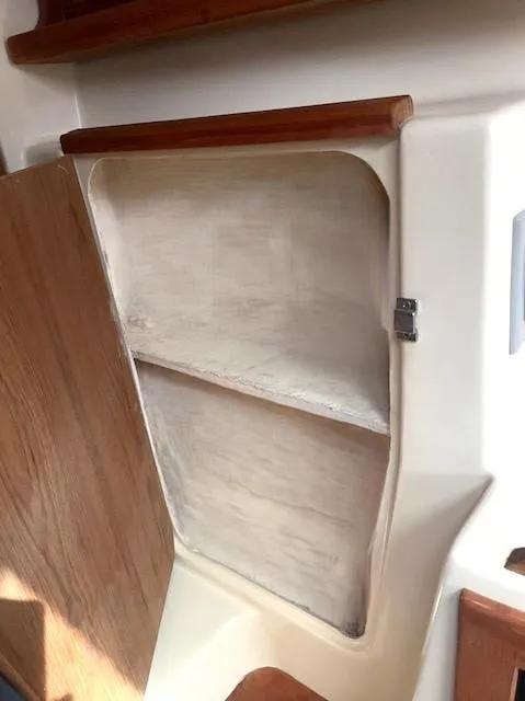 Slide: The Image of Open wooden cabinet on a 2010 Gemini 105Mc boat interior. - 22