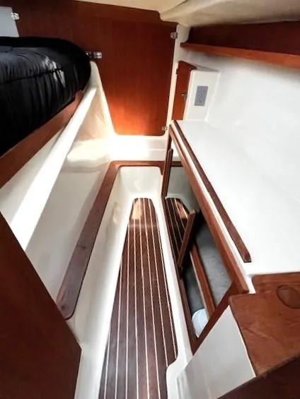 Slide: The Image of Interior of 2010 Gemini 105Mc sailboat with wood accents and storage compartments. - 28