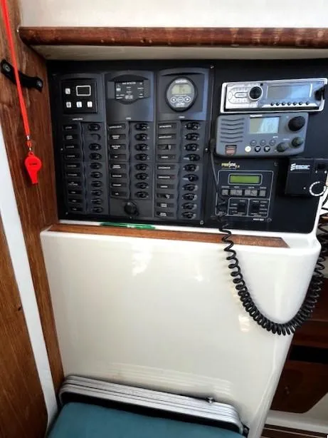 Slide: The Image of Electrical control panel on a 2010 Gemini 105Mc boat, featuring various switches and communication devices. - 29