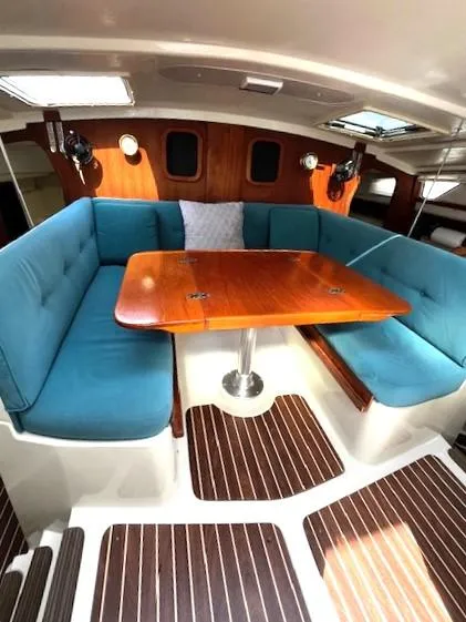 Slide: The Image of 2010 Gemini 105Mc interior with blue seating and wooden table. - 32