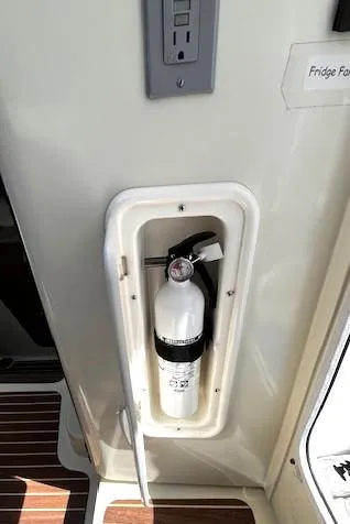 Slide: The Image of Fire extinguisher in a 2010 Gemini 105Mc boat interior compartment. - 33