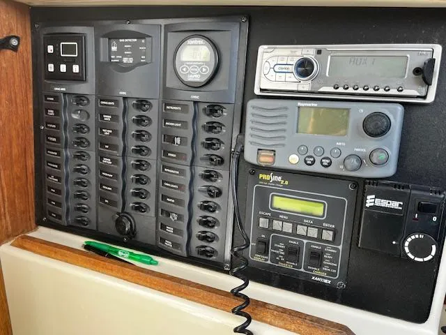 Slide: The Image of Control panel of a 2010 Gemini 105Mc boat with various switches and electronic devices. - 34