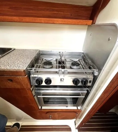 Slide: The Image of Compact kitchen area in a 2010 Gemini 105Mc boat with a two-burner stove. - 37