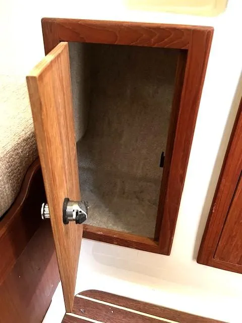 Slide: The Image of Open wooden cabinet door on 2010 Gemini 105Mc boat interior. - 45