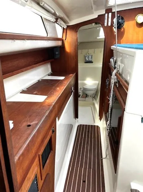 Slide: The Image of Interior of 2010 Gemini 105Mc sailboat with wooden cabinetry and compact bathroom. - 47
