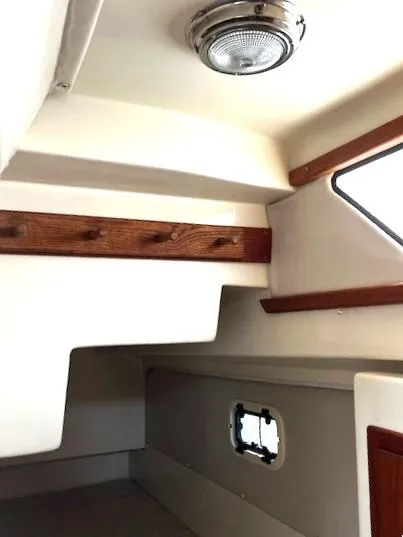 Slide: The Image of Interior cabin of 2010 Gemini 105Mc sailboat with wood accents and porthole. - 48