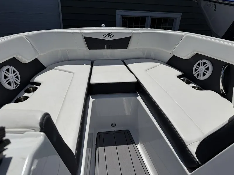 Slide: The Image of 2022 Monterey M225 boat interior with white and black seating. - 3
