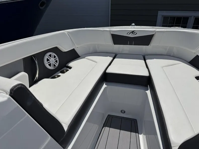 Slide: The Image of 2022 Monterey M225 boat interior with white and black seating. - 4